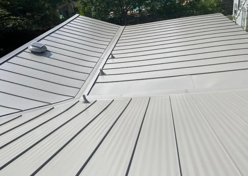Solar attic fan installed on a metal roof for Roof Ventilation in Round Lake